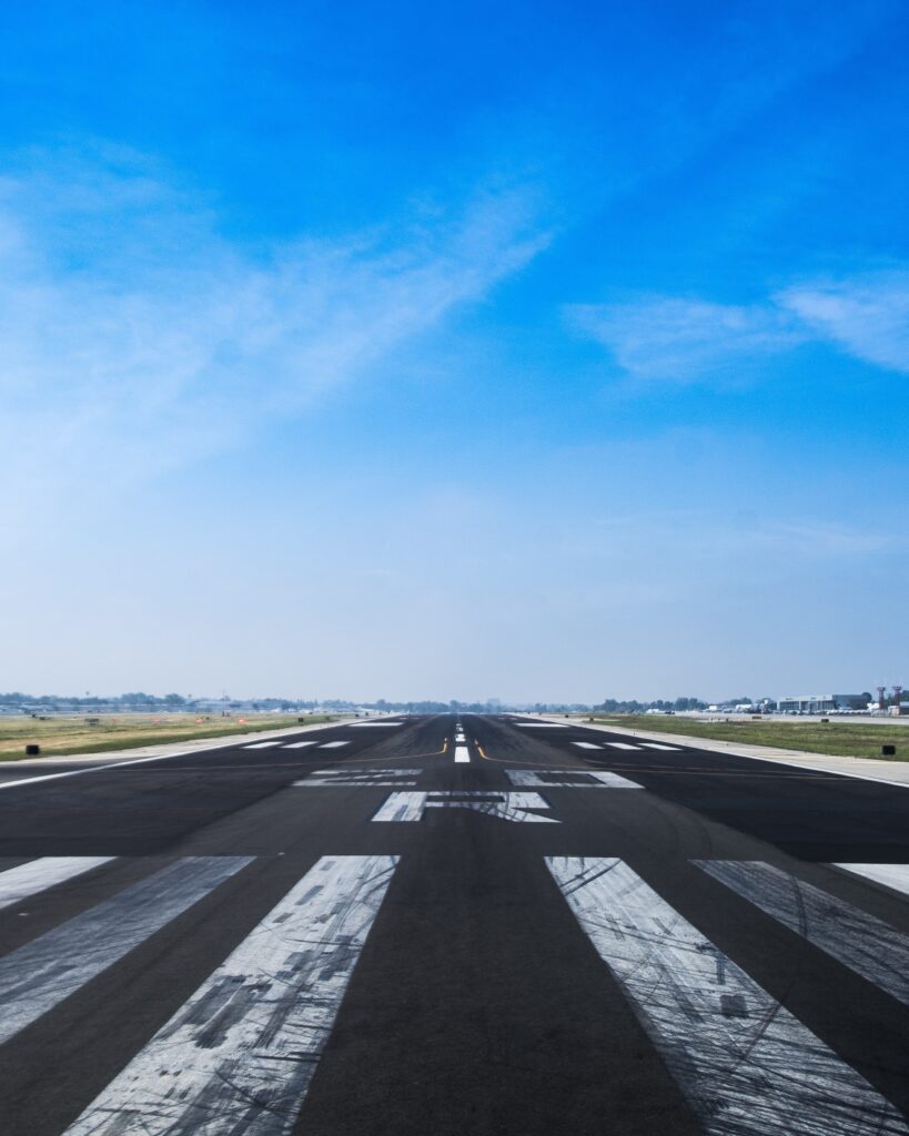 An empty airstrip from the view of a plane about to take off